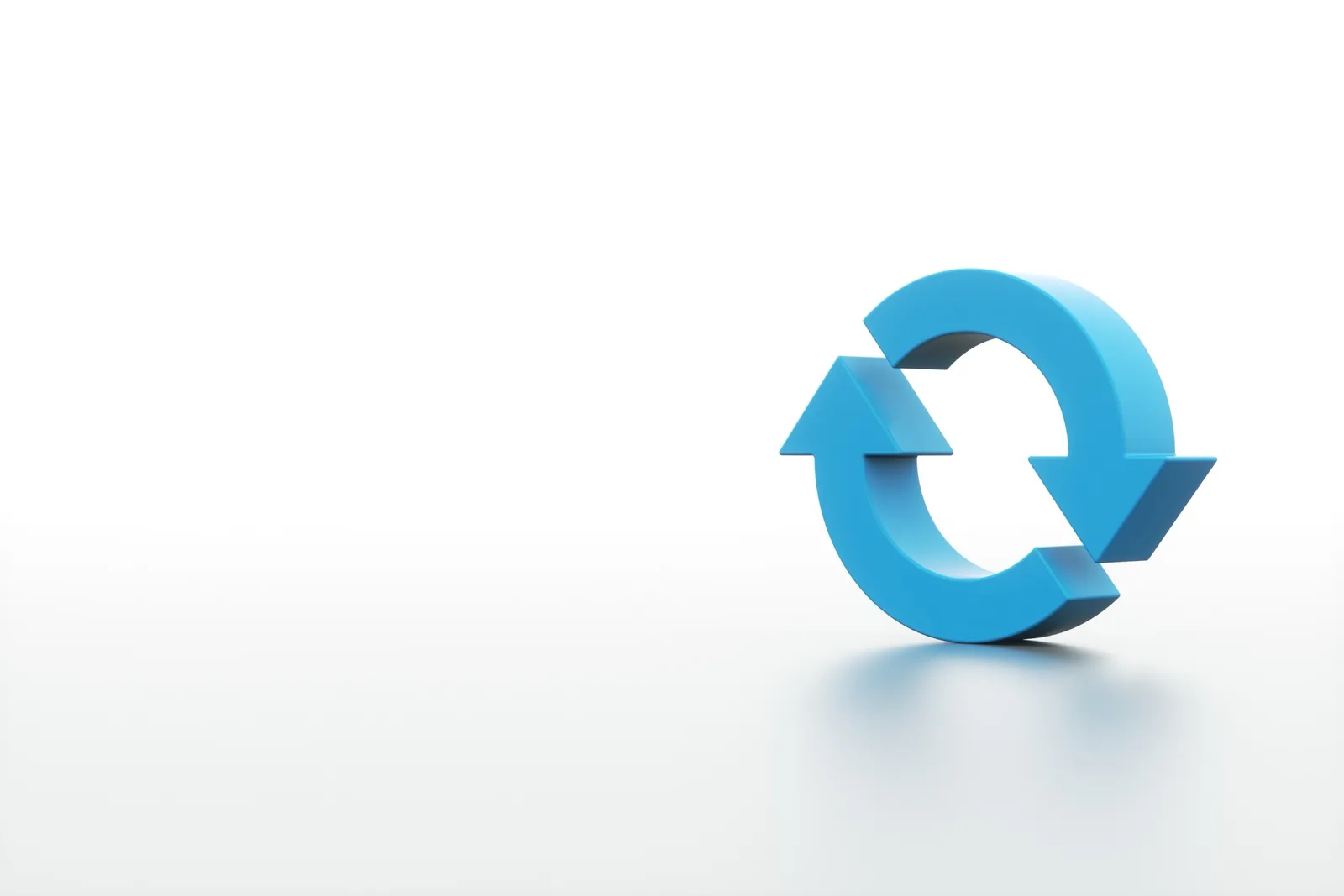 A blue 3D refresh icon, two curved arrows forming a loop, on a plain white background